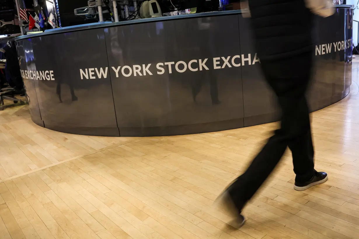 Traders work on the floor of the NYSE in New York