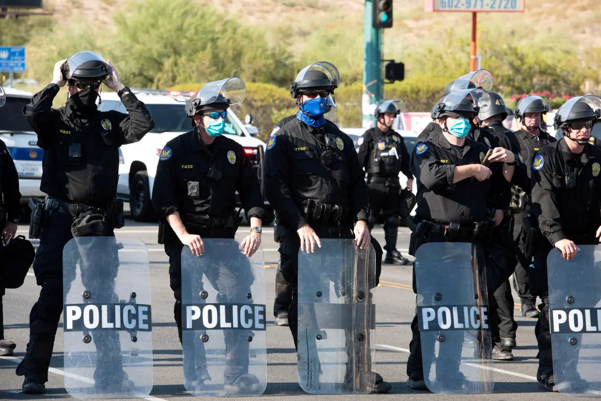 FILE PHOTO: Police block protesters during a visit by U.S, President Donald Trump to the Dream City Church in Phoenix