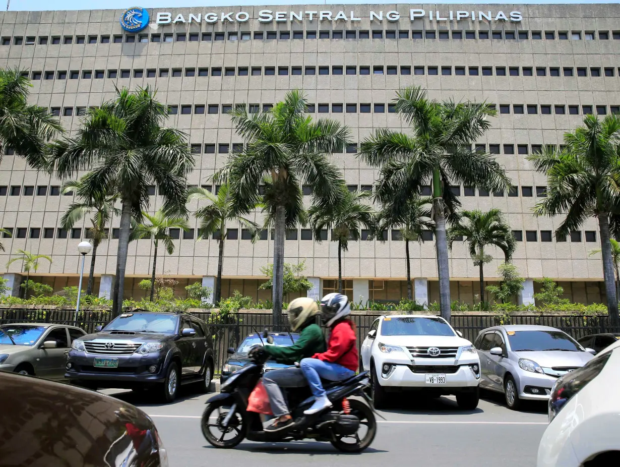 Motorcycle pases a building of the Bangko Sentral ng Pilipinas (Central Bank of the Philippines) in Manila