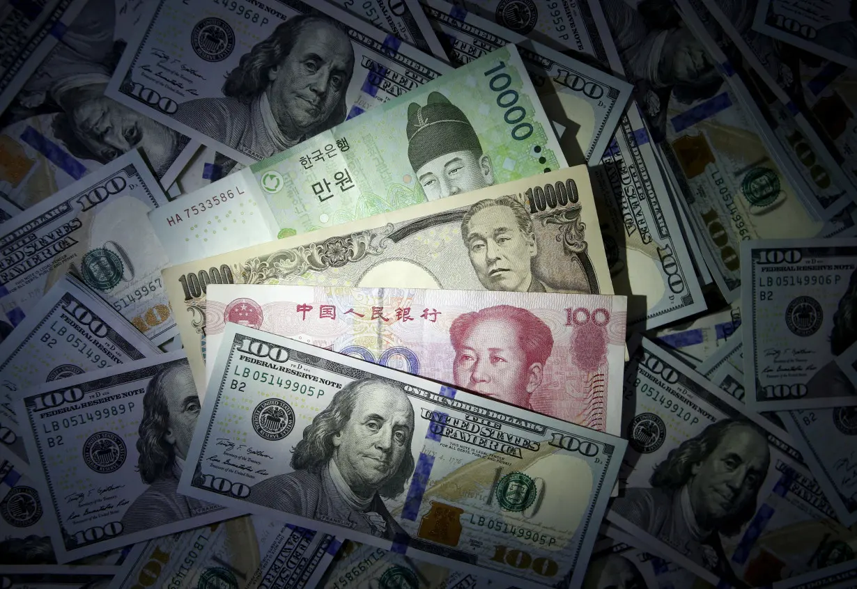 File photo illustration of South Korean won, Chinese yuan and Japanese yen notes seen on U.S. 100 dollar notes