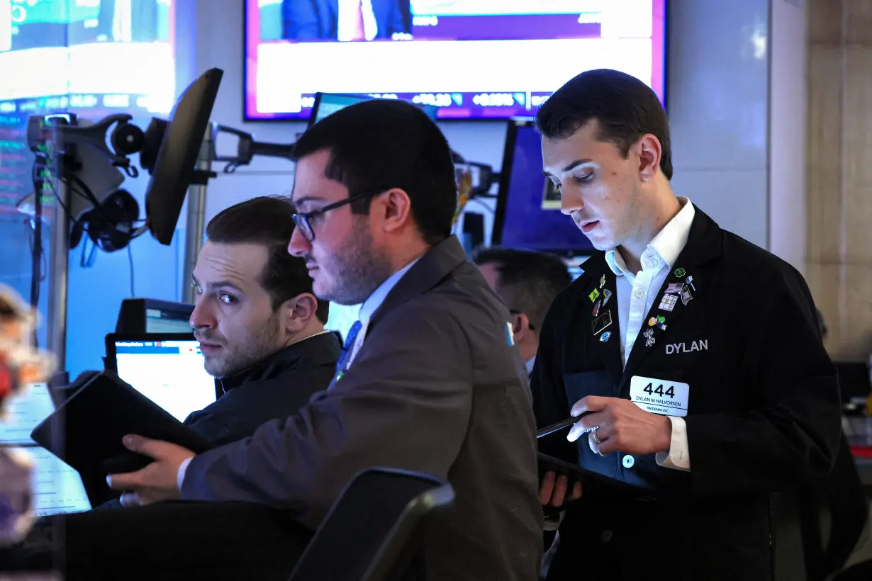 Traders work on the floor of the NYSE in New York