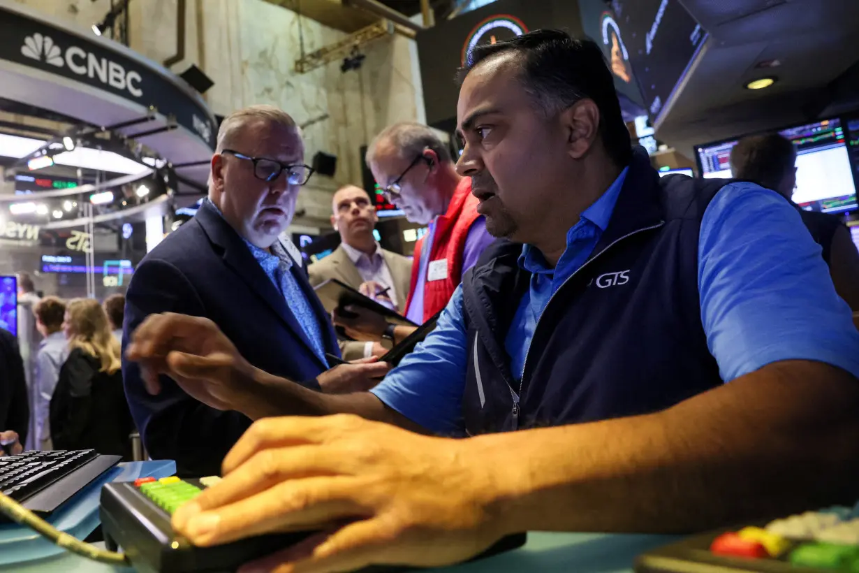 Traders work on the floor of the NYSE in New York