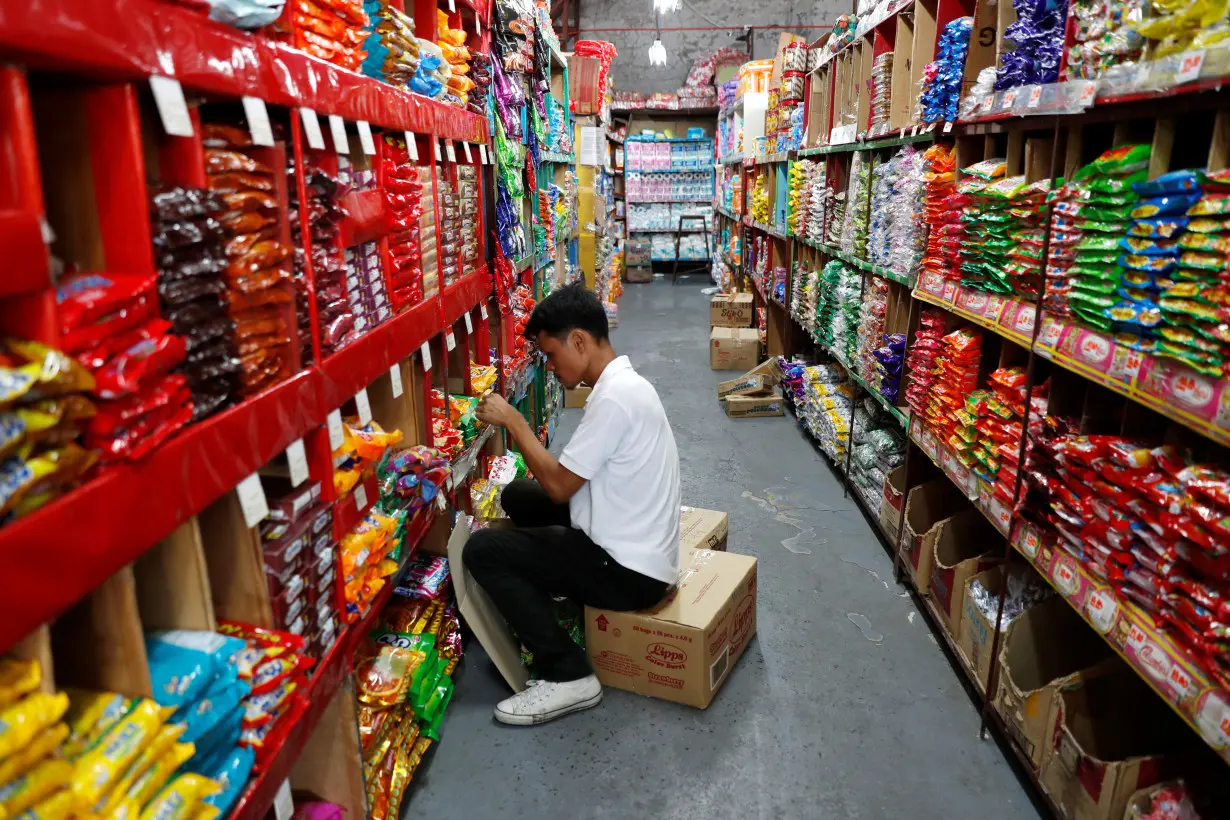 A worker sorts grocery items at a supermarket in Las Pinas