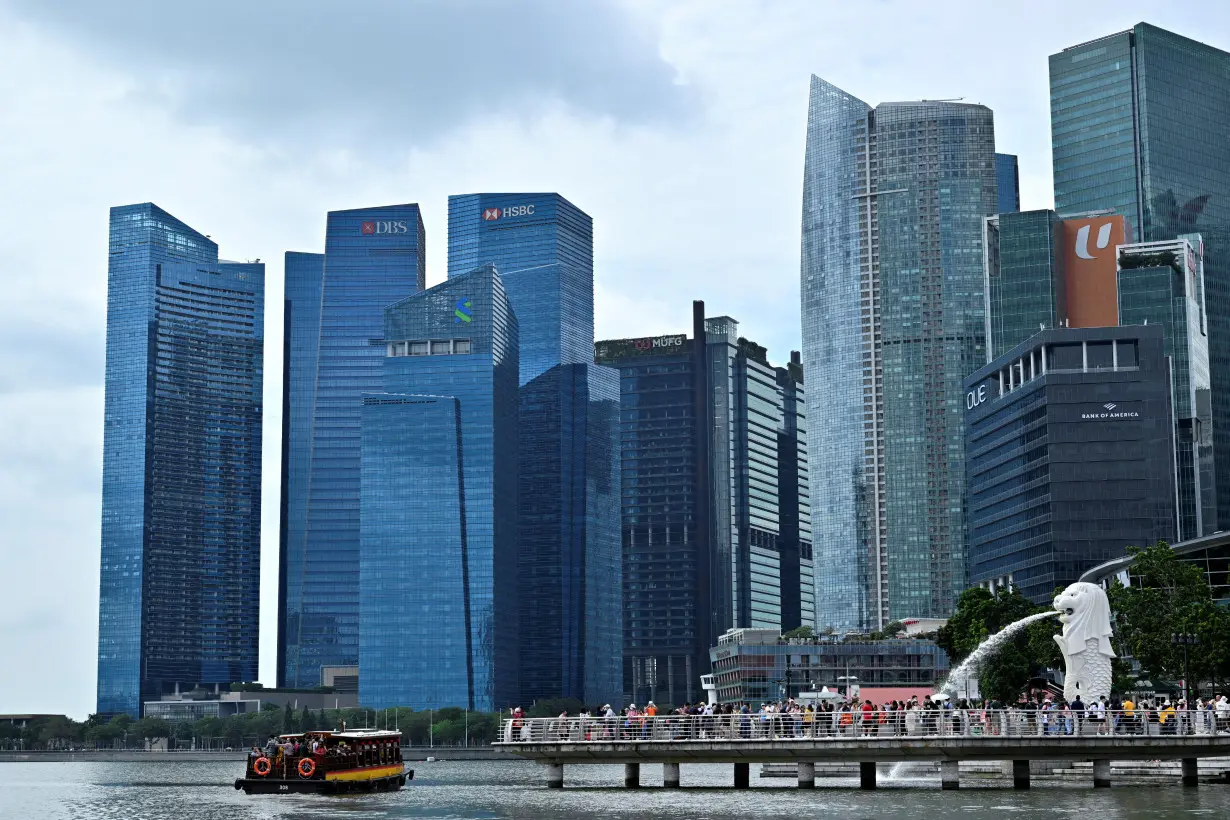 A view of the Merlion against the Singapore financial district in Singapore