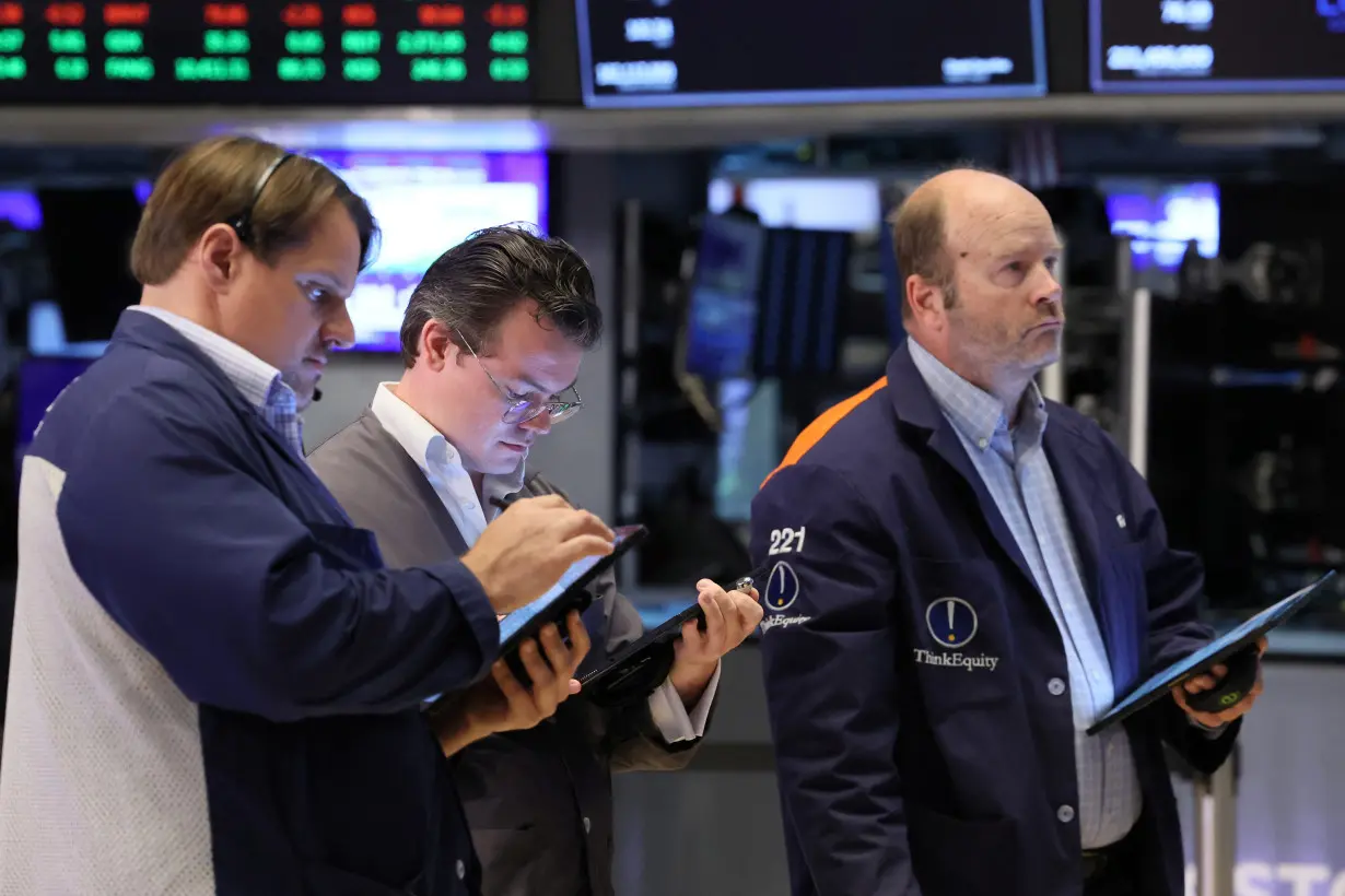 Traders work on the floor of the NYSE in New York