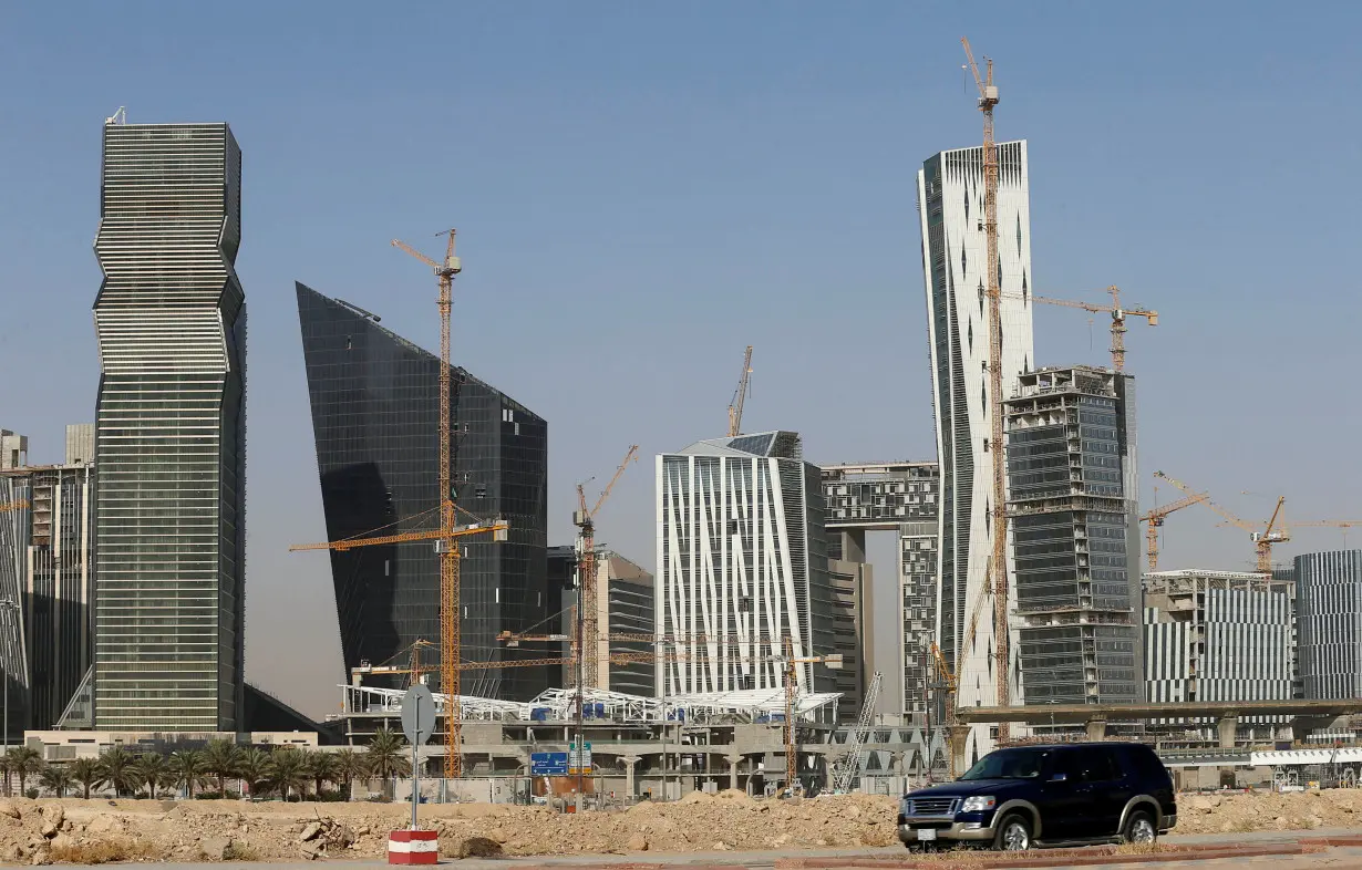 A vehicle drives past the King Abdullah Financial District in Riyadh