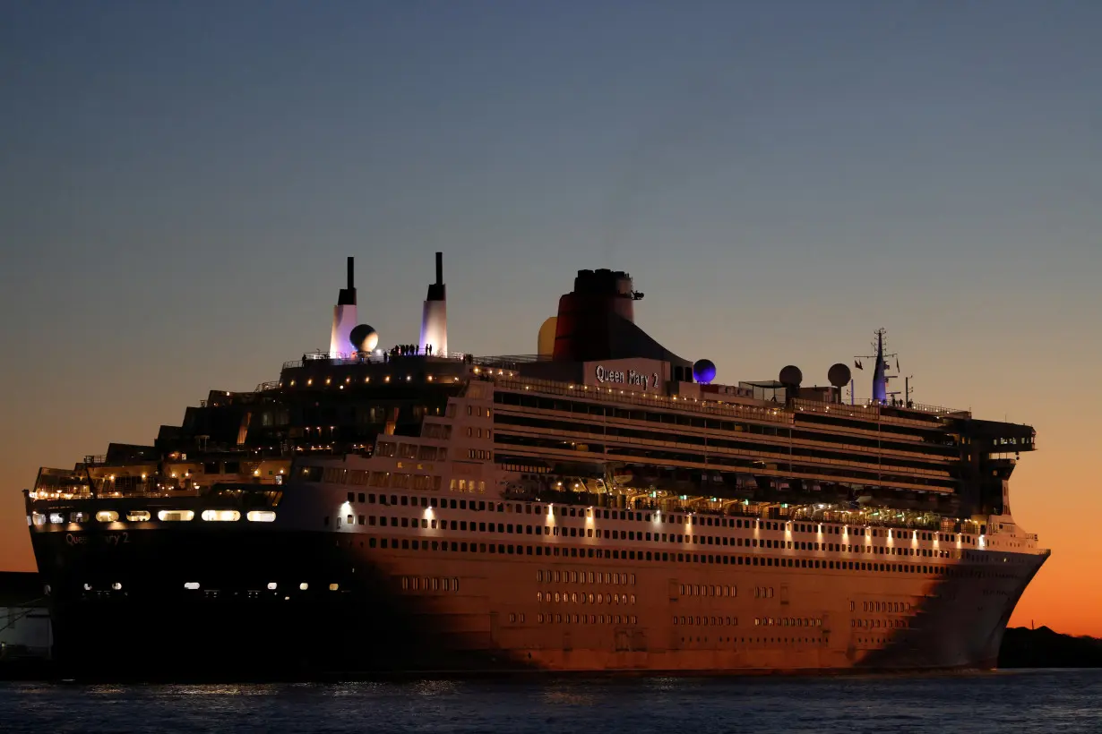 FILE PHOTO: The Queen Mary 2 cruise ship by Cunard Line, owned by Carnival Corporation & plc. is seen docked at Brooklyn Cruise Terminal in Brooklyn, New York City