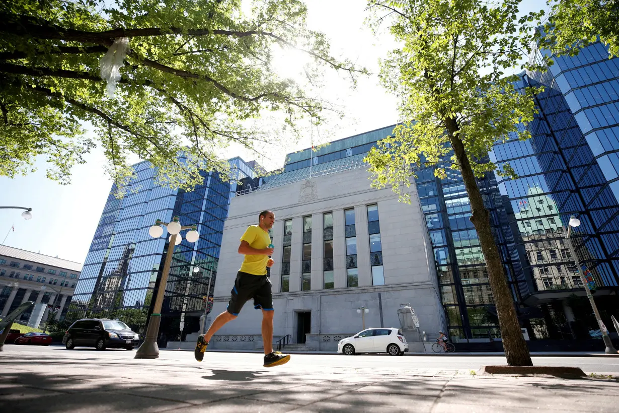 FILE PHOTO: A jogger runs past the Bank of Canada building in Ottawa