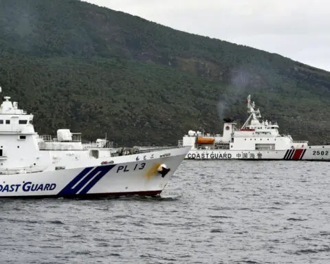 Chinese armed vessels patrol waters around disputed islands, angering Japan