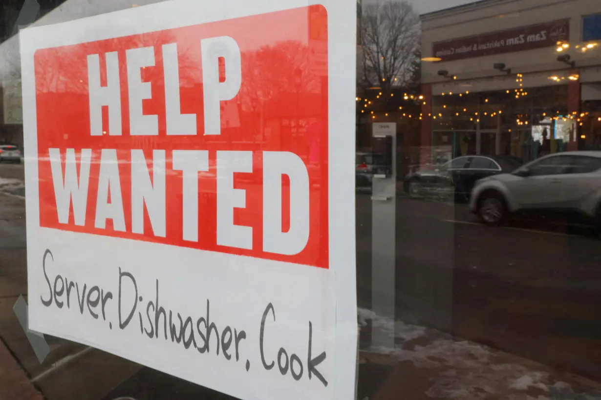 FILE PHOTO: A “Help Wanted” sign hangs in restaurant window in Medford