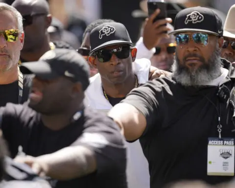Deion Sanders makes most of rival coach's comments about him always wearing sunglasses and a hat