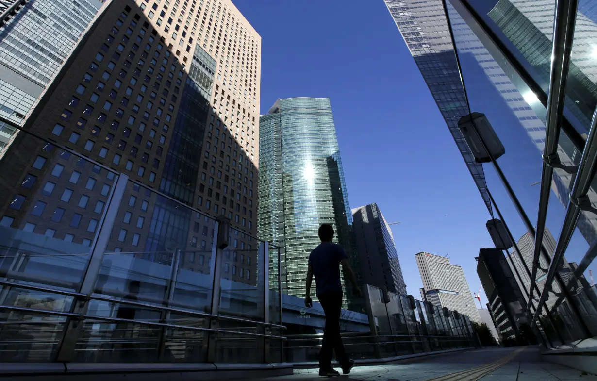 A businessman walks in Tokyo's business district, Japan