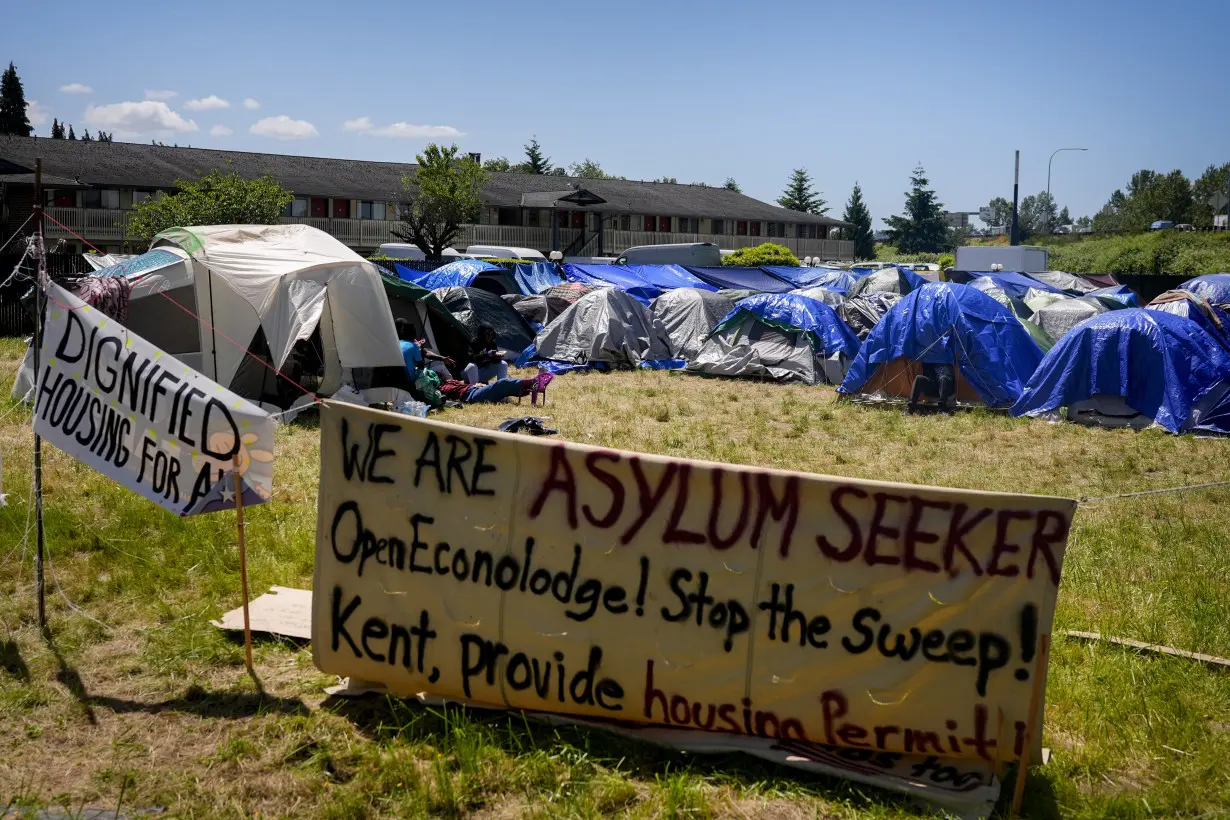 Hundreds of asylum-seekers are camped out near Seattle. There's a vacant motel next door