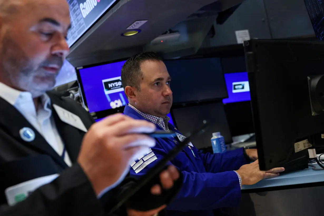 Traders work on the floor of the NYSE in New York