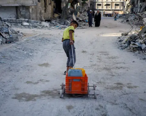 Palestinian children dream of school in Gaza water queues