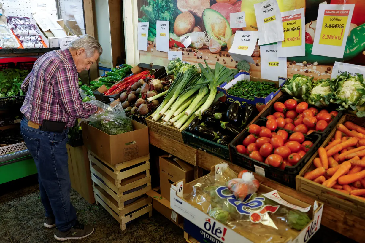 A man buys food in a fruit store in Vecindario