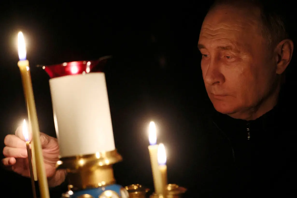 FILE PHOTO: Russian President Putin lights a candle in memory of the victims of the Crocus City Hall attack, in Moscow Region