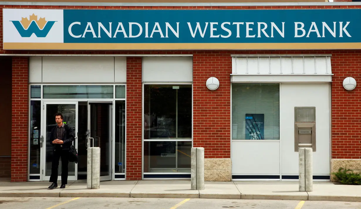 FILE PHOTO: A customer walks out of a Canadian Western Bank branch in Calgary.