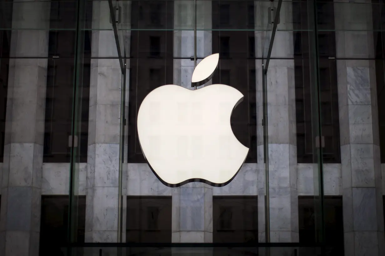 An Apple logo hangs above the entrance to the Apple store on 5th Avenue in the Manhattan borough of New York City