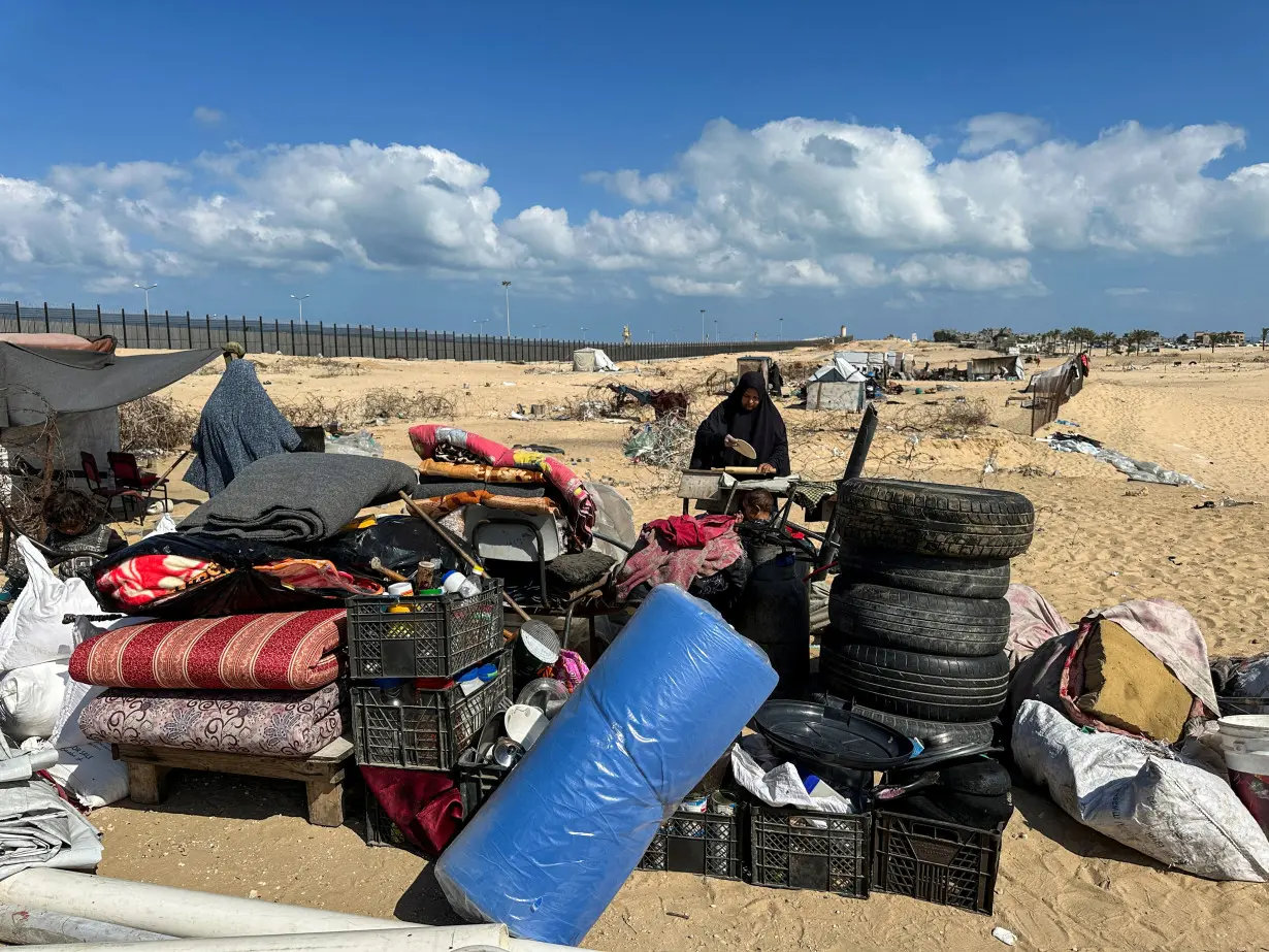 Displaced Palestinians take shelter at the border with Egypt, during an Israeli military operation, in Rafah