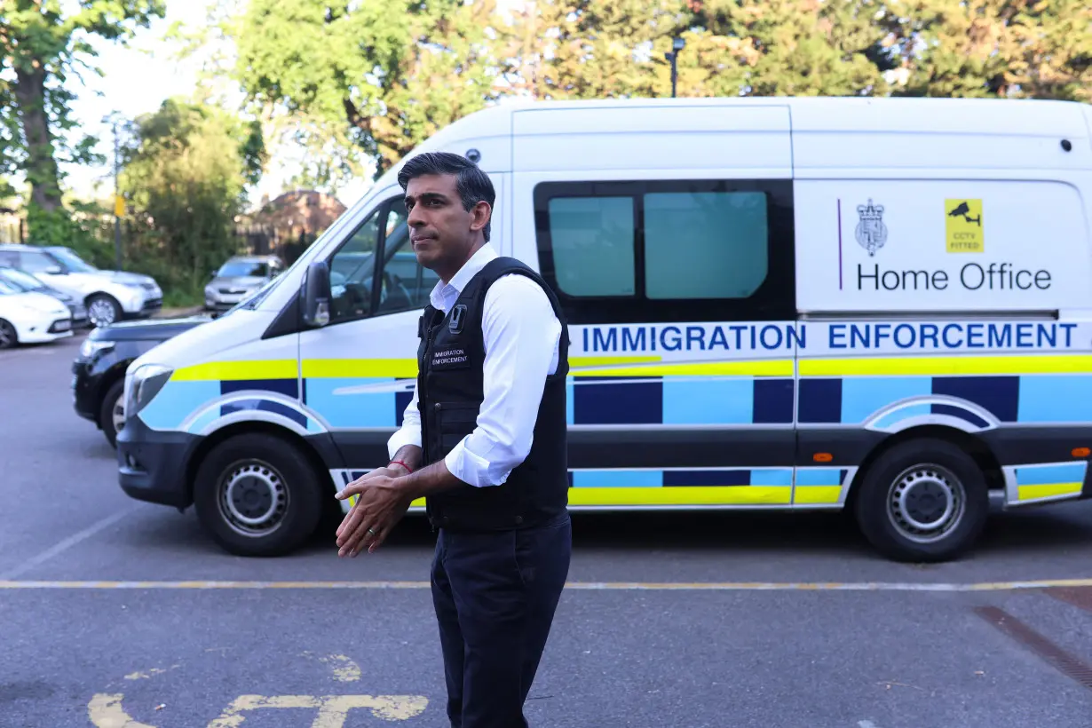 British Prime Minister Rishi Sunak watches an immigration raid in northwest London