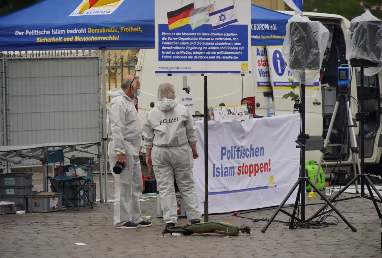 FILE PHOTO: Police investigators work at the scene where a man attacked people at a far right-wing information stand of the Buergerbewegung Pax Europa in Mannheim