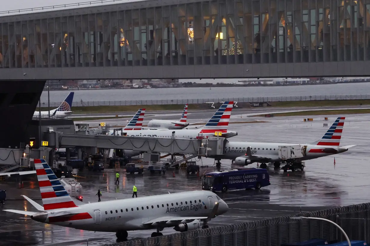 FILE PHOTO: American Airlines planes are seen at gates at LaGuardia Airport ahead of the Thanksgiving holiday, in New York City