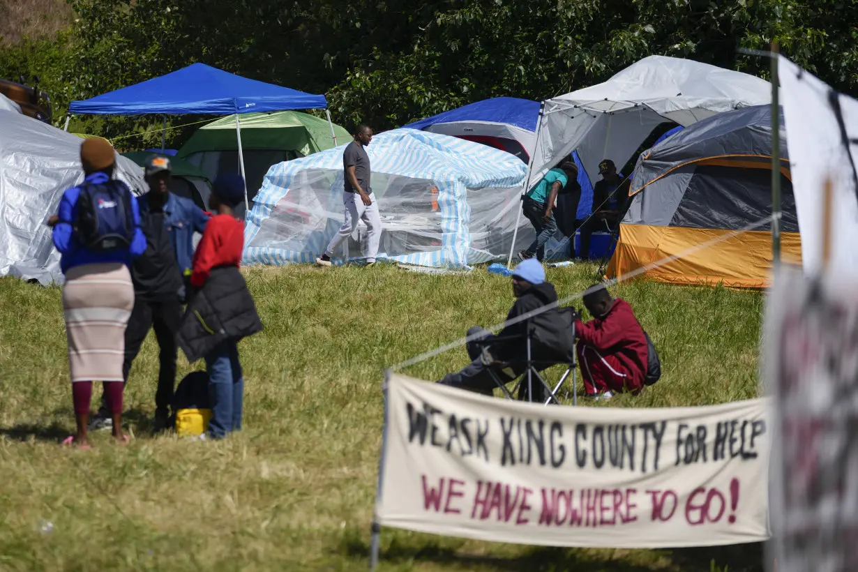 Hundreds of asylum-seekers are camped out near Seattle. There's a vacant motel next door