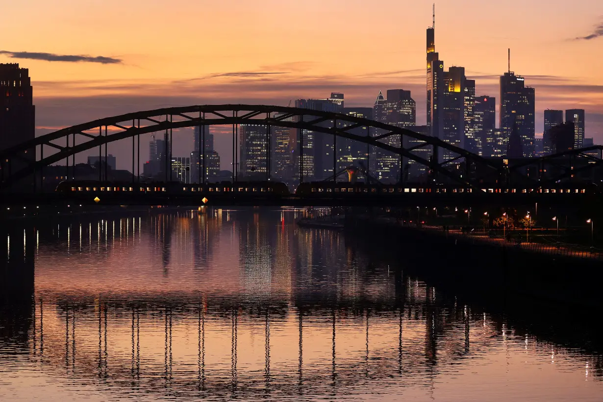 Sun sets over the skyline and ECB in Frankfurt