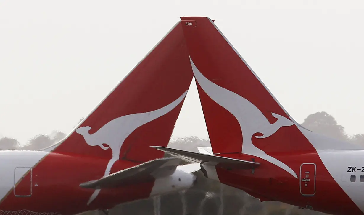 FILE PHOTO: Two Qantas passenger jets cross each other at Kingsford Smith International airport in Sydney