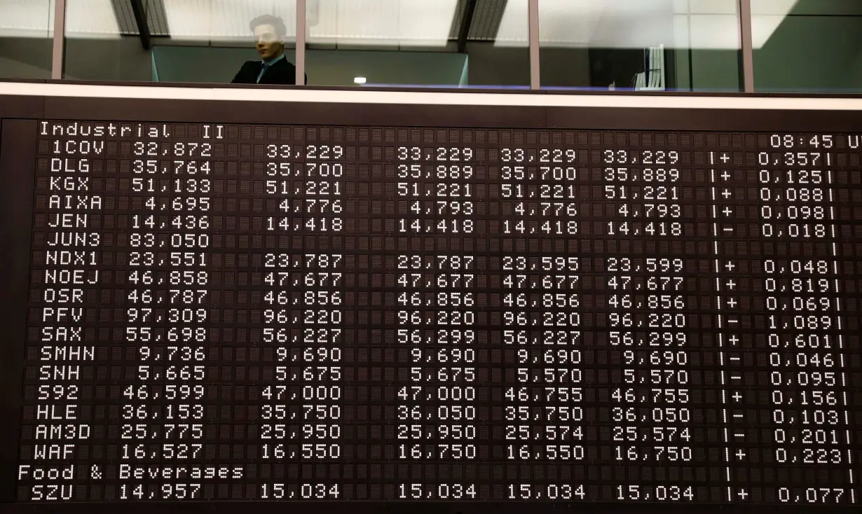 A visitor looks into the trading room of Frankfurt's stock exchange in Frankfurt