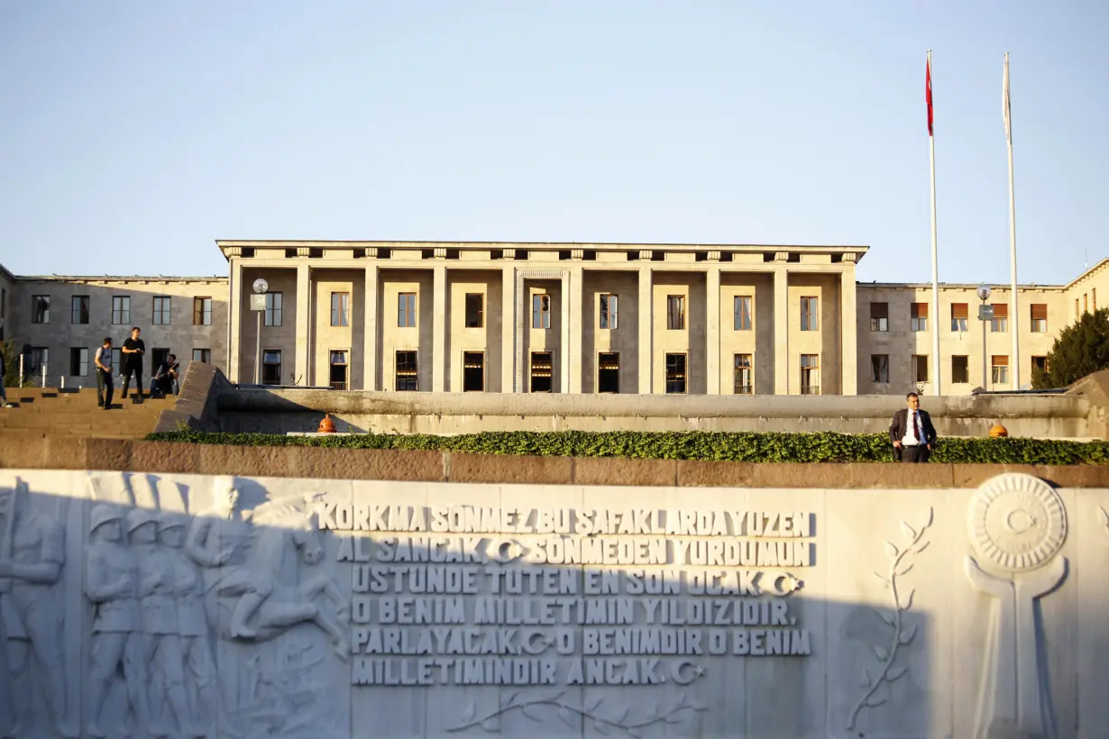 People are pictured outside the parliament building in Ankara