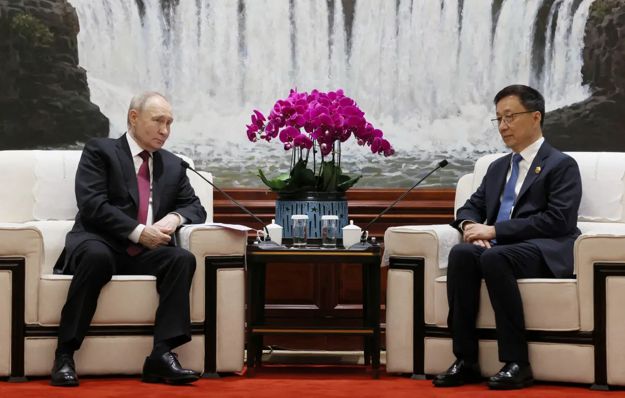 FILE PHOTO: Russian President Vladimir Putin and Chinese Vice President Han Zheng meet in Harbin