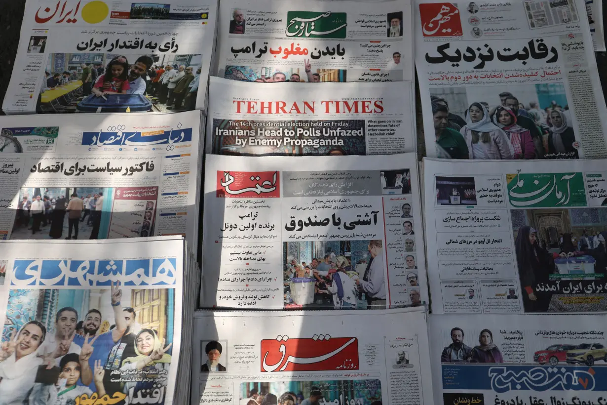 Newspapers with a cover picture of Iran's presidential election are seen in Tehran