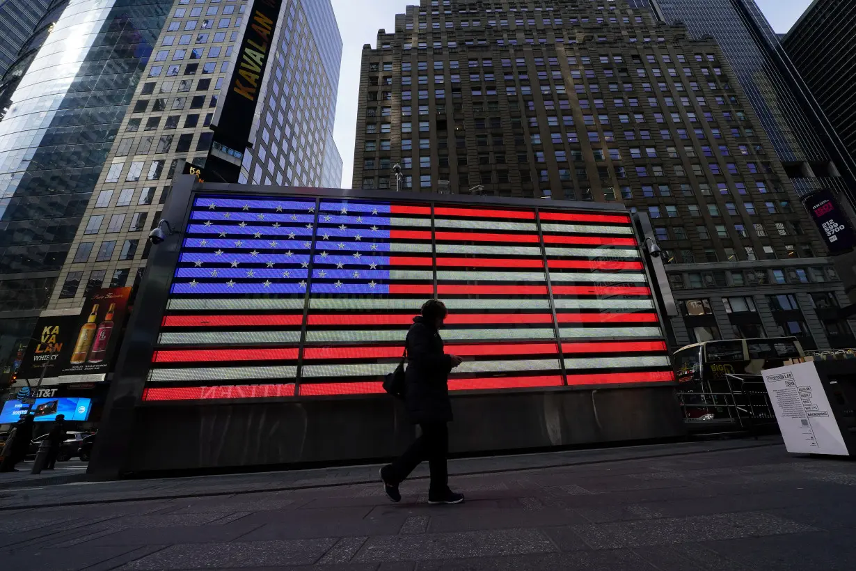 A pedestrian walks though Times Square in New York