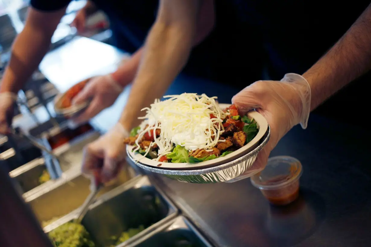 An employee prepares a burrito bowl at a Chipotle Mexican Grill Inc. restaurant in Louisville, Kentucky, in 2019.
