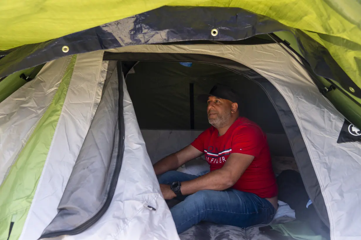 Hundreds of asylum-seekers are camped out near Seattle. There's a vacant motel next door