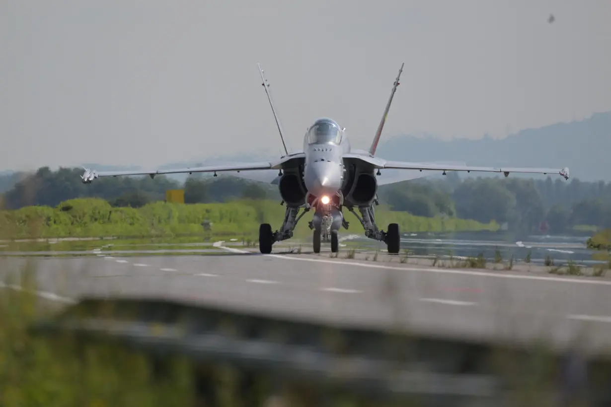 A Swiss Air Force F/A-18 fighter jet lands on the motorway during the Alpha Uno drill in Payerne