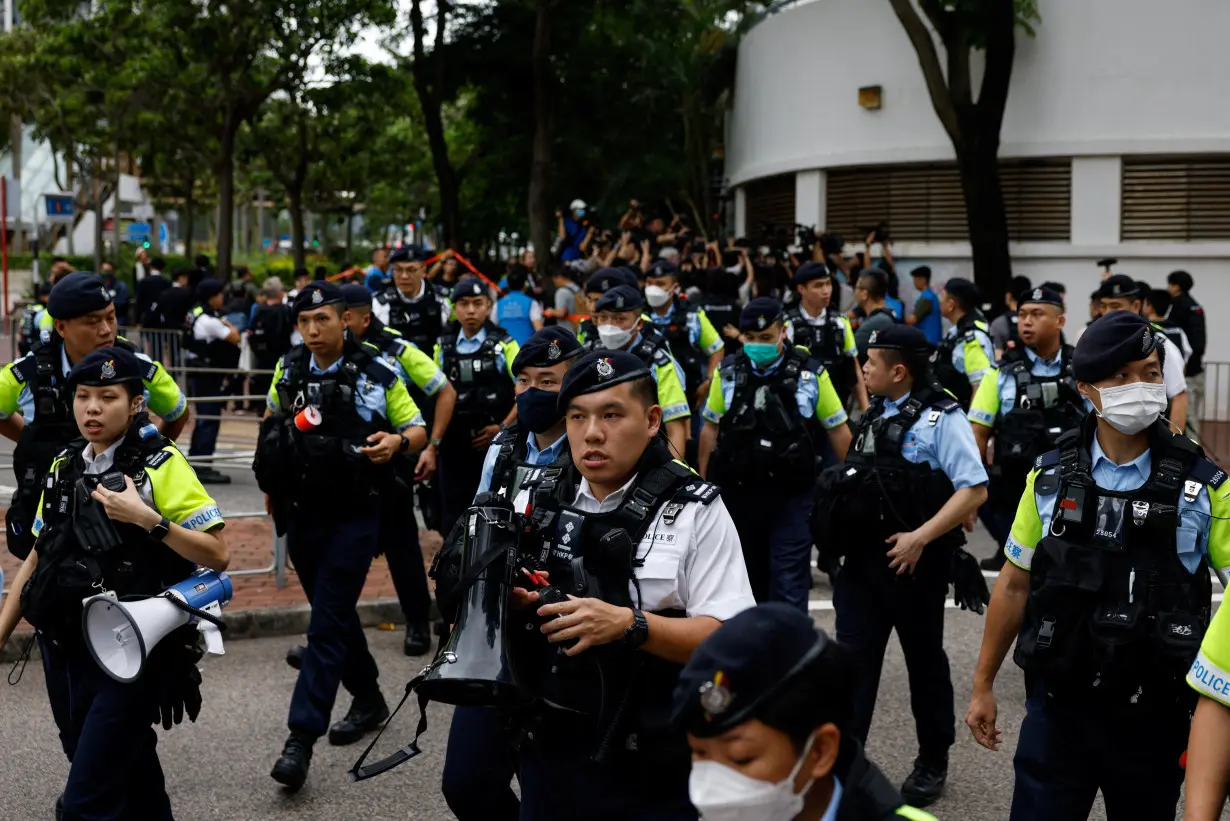 FILE PHOTO: Police stand guard outside the West Kowloon Magistrates' Courts building during the verdict of the 47 pro-democracy activists charged under the national security law, in Hong Kong