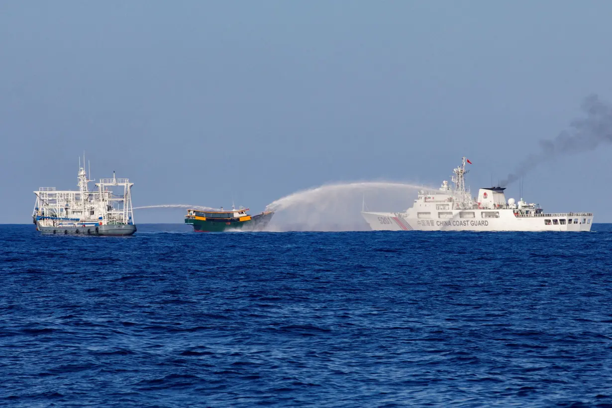 FILE PHOTO: Chinese Coast Guard vessels fire water cannons towards a Philippine resupply vessel Unaizah May 4 on its way to a resupply mission at Second Thomas Shoal in the South China Sea