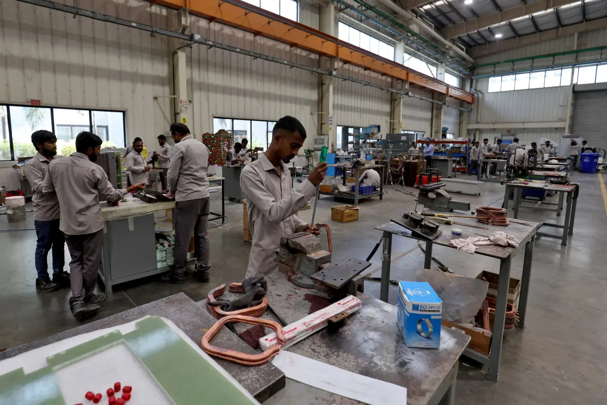 FILE PHOTO: Employees assemble an electric transformer inside a manufacturing unit of Electrotherm (India) Private Limited at Sanand GIDC (Gujarat Industrial Development Corporation), on the outskirts of Ahmedabad