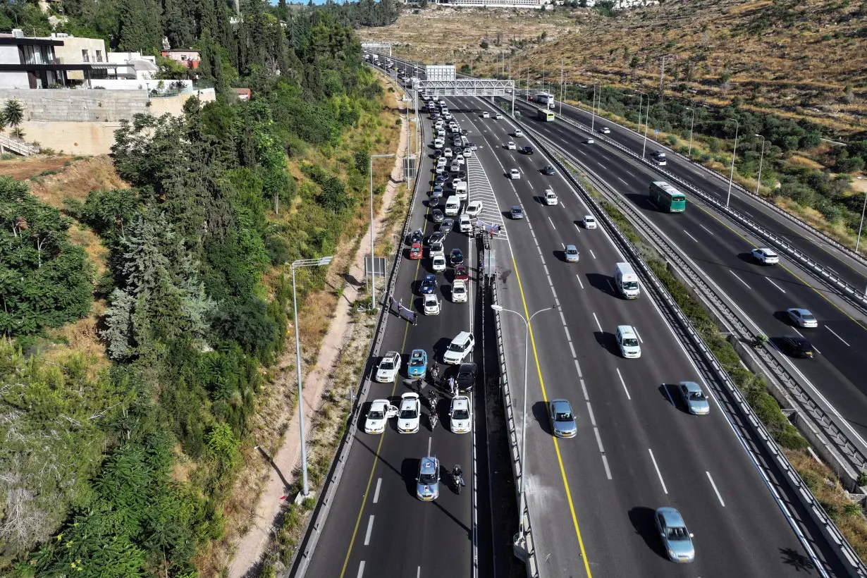 A drone photo shows protestors attempting to block traffic during a protest against Israeli Prime Minister Benjamin Netanyahu's government and calling for the release of hostages kidnapped during the deadly October 7 attack on Israel, in Jerusalem