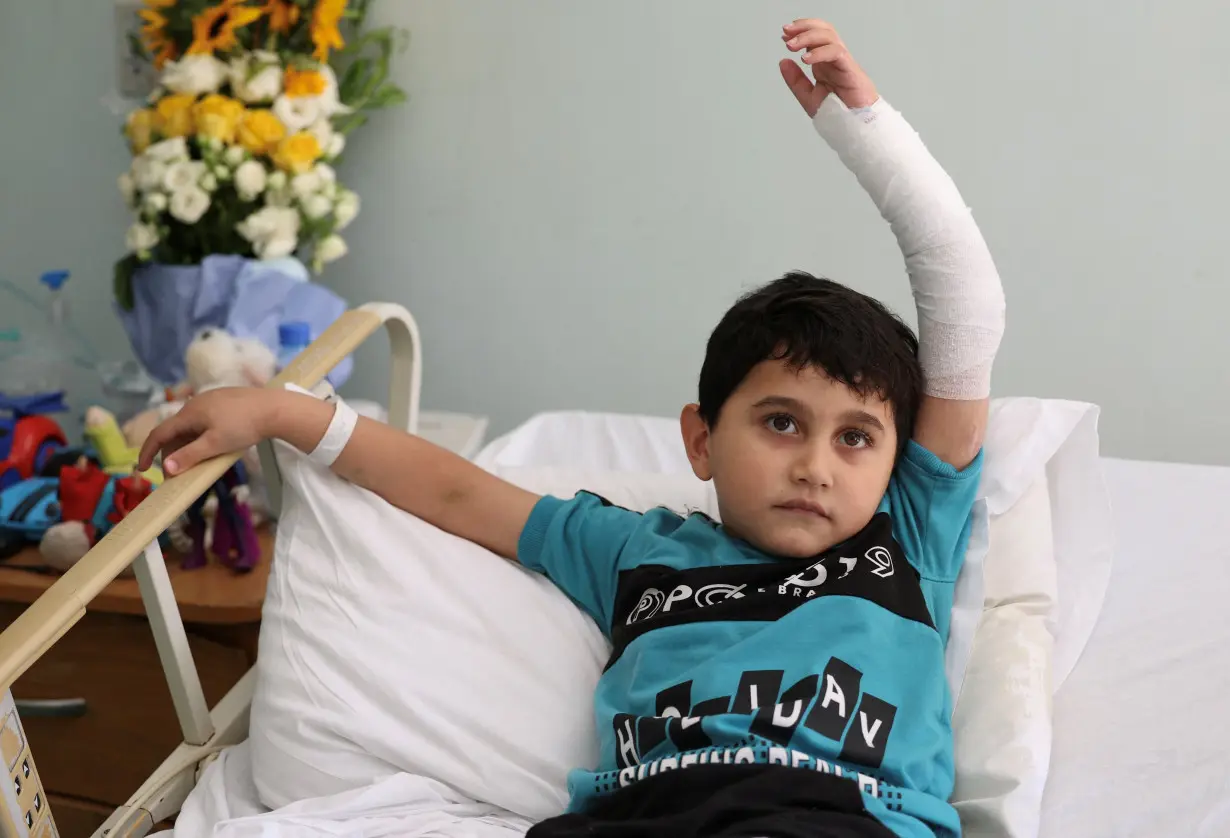 5-year-old Adam Afana, the first Palestinian child wounded in Israel's war on Gaza to land in Lebanon, lies on a hospital bed as he receives medical care at the American University of Beirut's Medical Center in Beirut