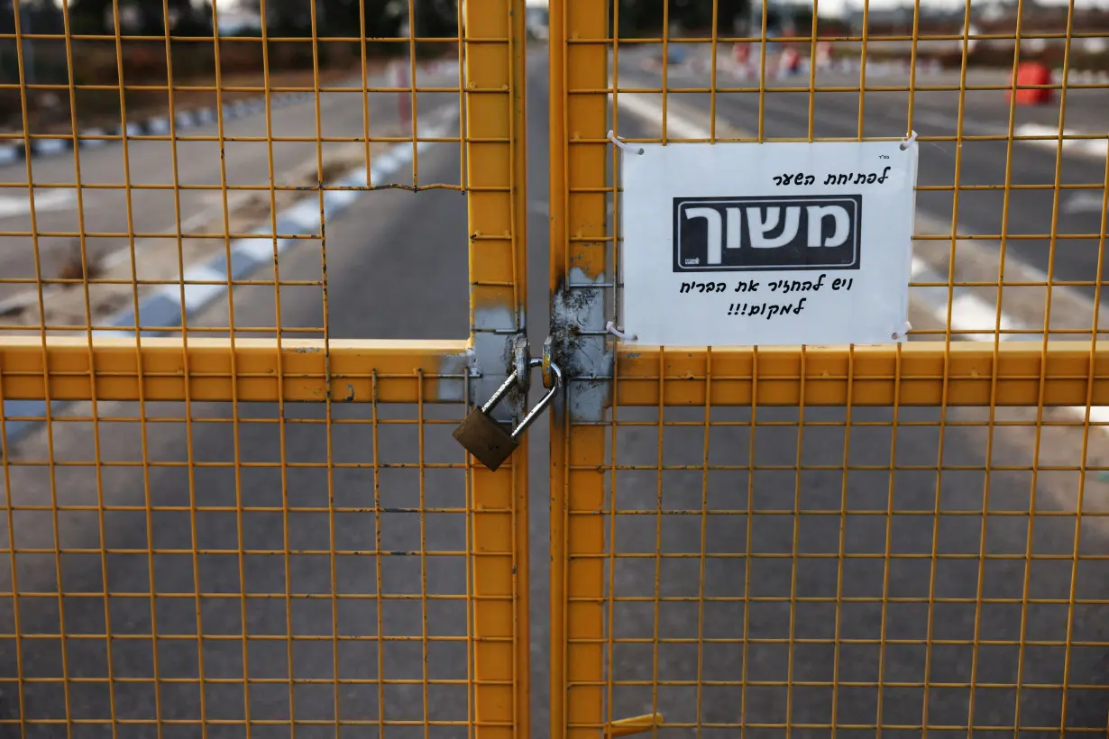 FILE PHOTO: A fence sits locked at the entrance to the Kerem Shalom border crossing, as military operations continue in the southern Gaza city of Rafah, at an area outside Kerem Shalom
