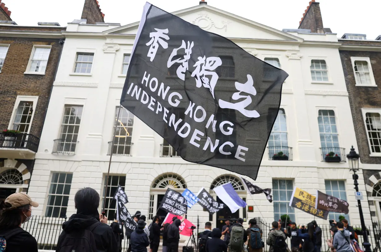 FILE PHOTO: People demonstrate outside the Hong Kong Economic and Trade Office, after three men were charged with assisting Hong Kong's foreign intelligence service in Britain, in London