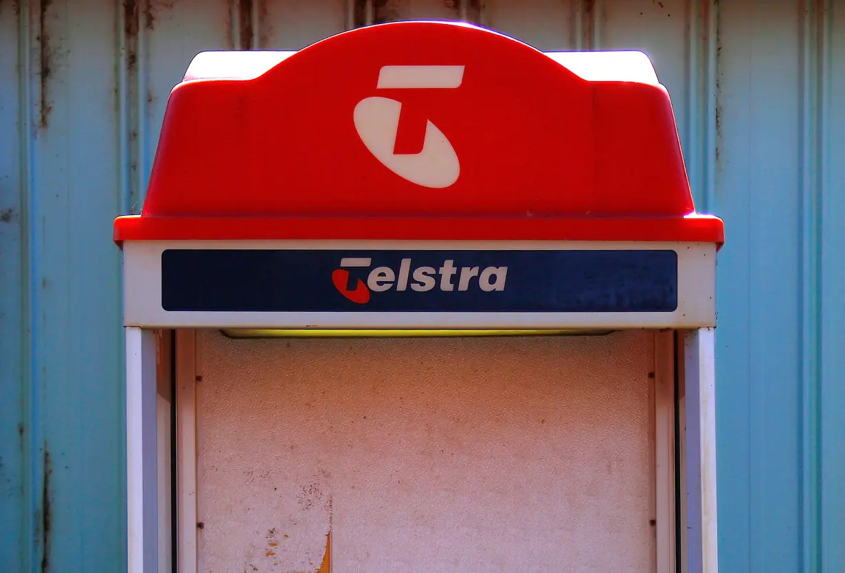 FILE PHOTO: A public phone booth displaying the logo for Telstra Corp Ltd, Australia's biggest telecommunications company, stands outside the Cooladdi Post Office and motel, located in the town of Cooladdi in southwestern Queensland