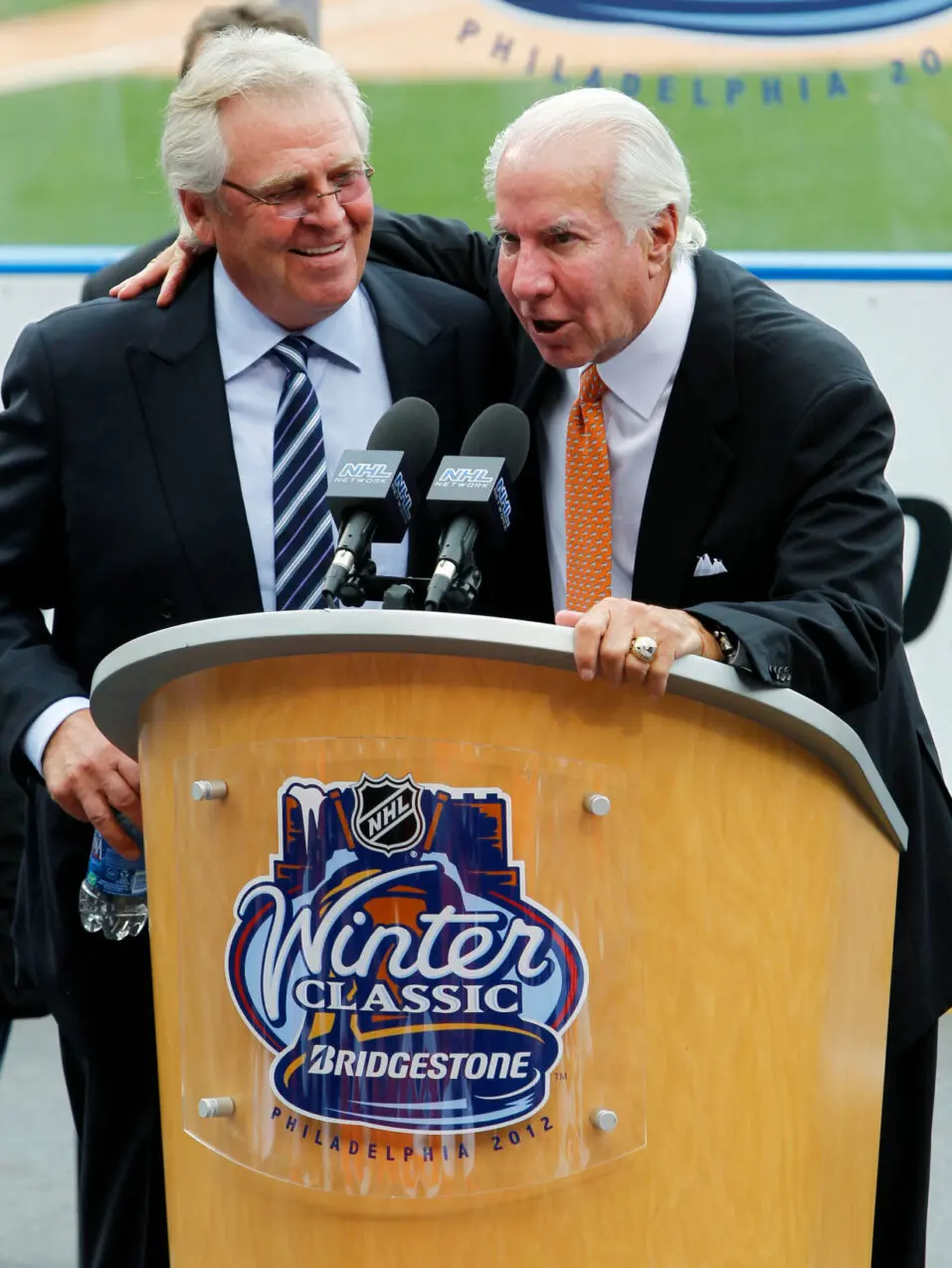 Rangers President Sather is joined at the podium by Philadelphia Flyers Chairman Snider as they joke about the 2012 Winter Classic hockey game to be played on January 2 at Citizens Bank Ballpark during a news conference at the ballpark in Philadelphia