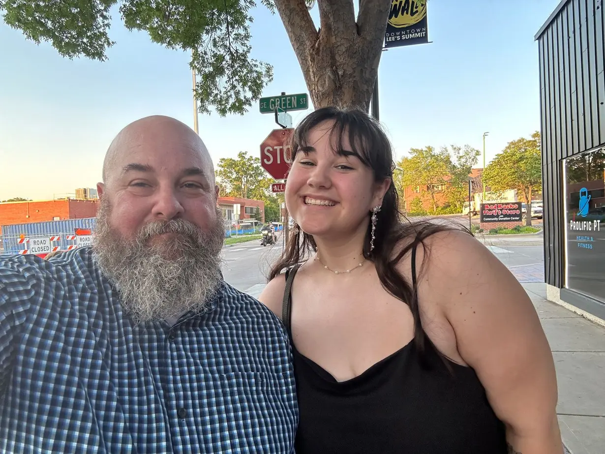 Writer Shannon Carpenter and his daughter, Vivi, 18, celebrate her high school graduation in Lee's Summit, Missouri. He's proud his daughter had the confidence to come out to him three years ago.
