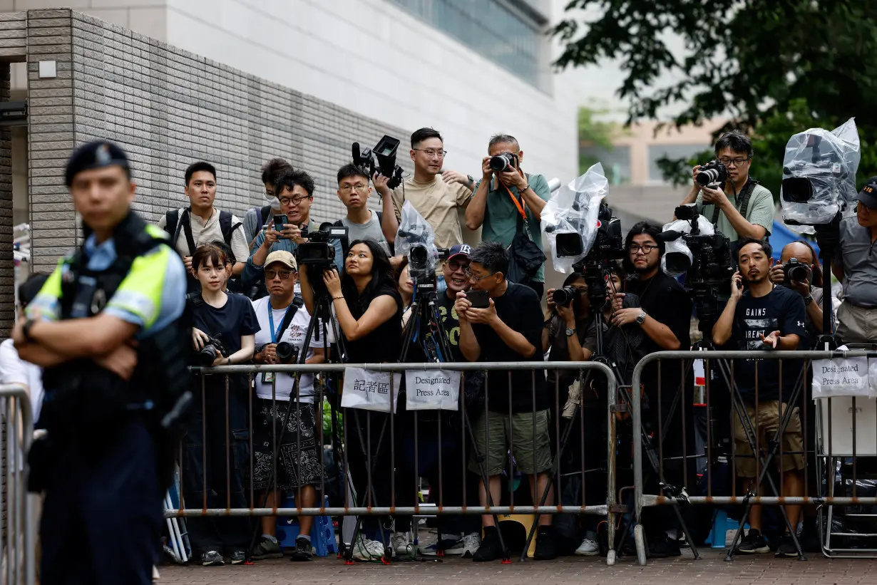 Members of media stand outside the West Kowloon Magistrates' Courts building, before the verdict of the 47 pro-democracy activists charged under the national security law, in Hong Kong