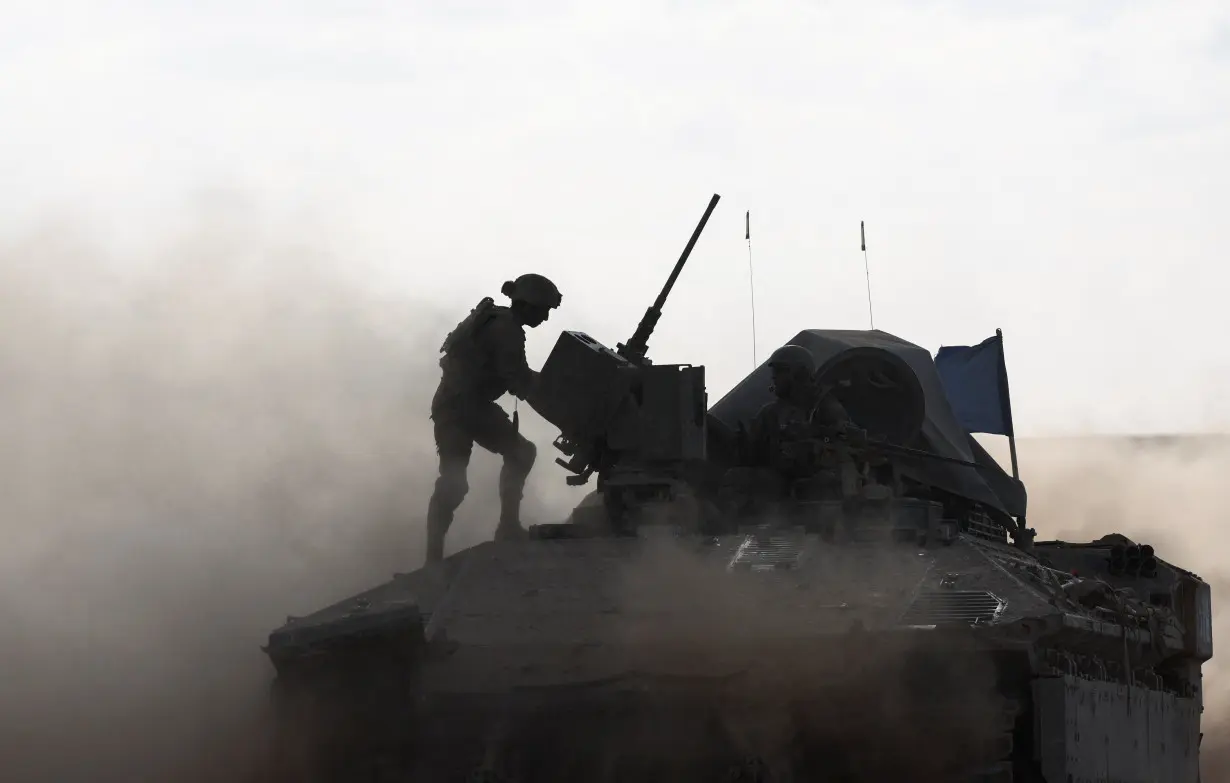 An Israeli armoured personnel carrier (APC) operates, amid the ongoing conflict between Israel and the Palestinian Islamist group Hamas, near Israel's border with Gaza in southern Israel